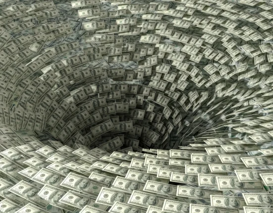 Image of $100 bills swirling into a hole