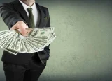 Image of a businessperson fanning out money