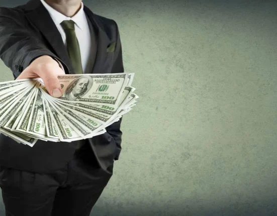 Image of a businessperson fanning out money