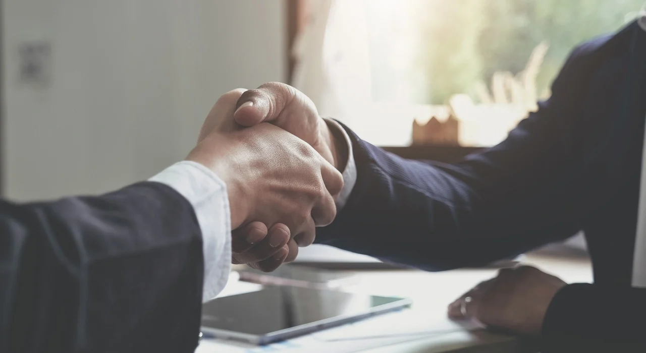Image of two businesspeople shaking hands