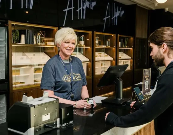 Image of customer making a purchase at a retail store owned by The Cannabist Co.